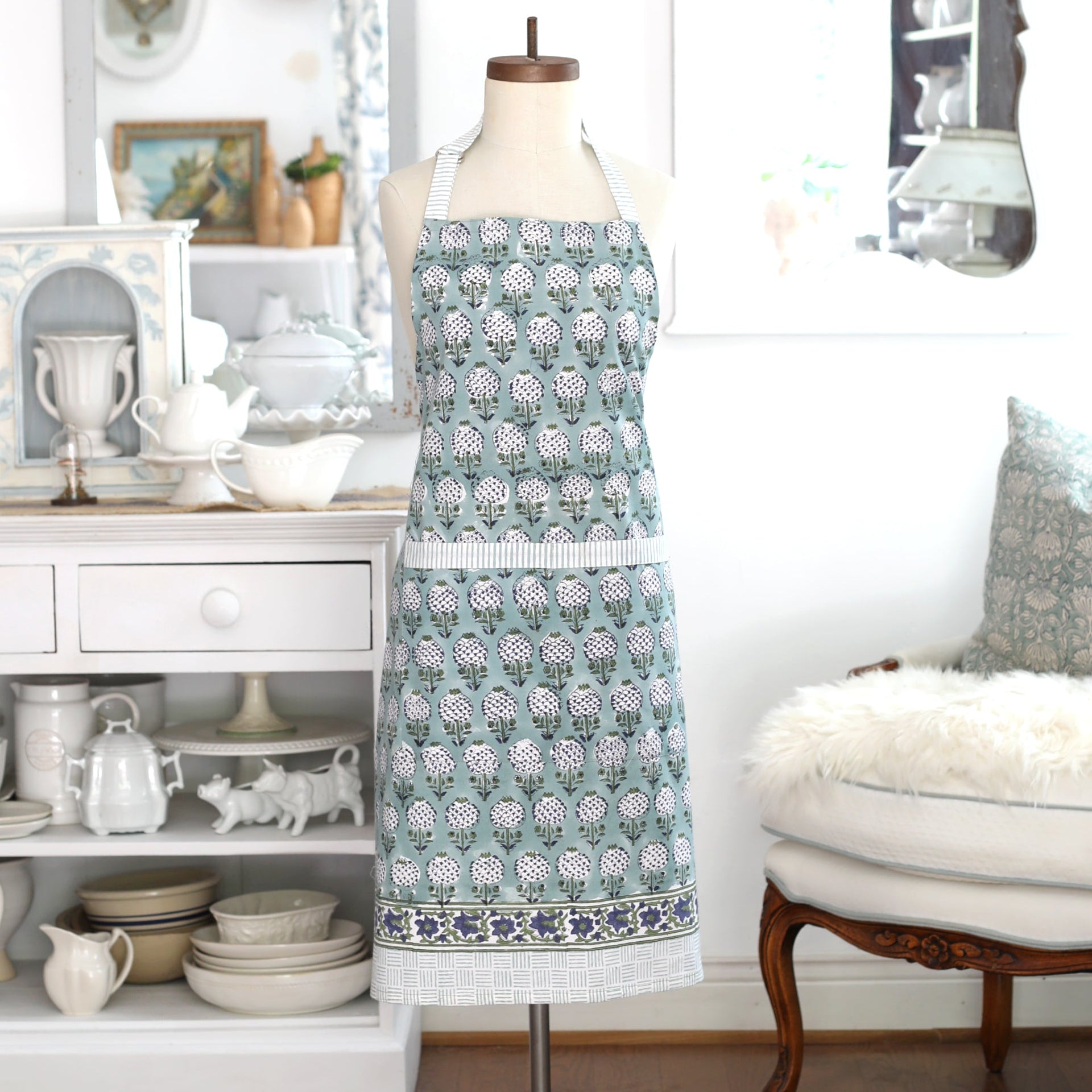Granada—Spanish for pomegranate—has symbolized abundance and prosperity for centuries. Inspired by the pomegranate trees of Granada, Spain, our stylized motif is hand block printed in smokey blue-teal hues. With roomy pockets and an easy, comfortable fit, the Granada apron blends everyday function with timeless artistry—perfect for the cook, gardener, or maker at heart.