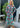 Woman wearing a colorful floral dress standing outdoors.